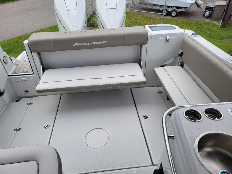Slide: The Image of 2024 Finseeker 280 DC boat interior with seating and cup holders. - 10
