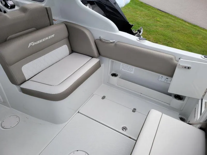 Slide: The Image of 2024 Finseeker 280 DC boat interior seating area with gray and white upholstery. - 11