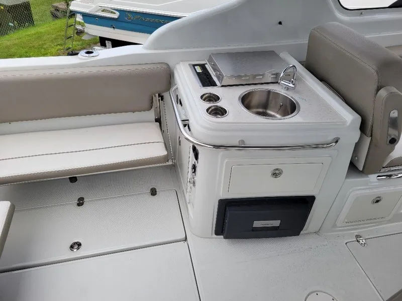 Slide: The Image of 2024 Finseeker 280 DC boat interior with sink and seating area. - 13