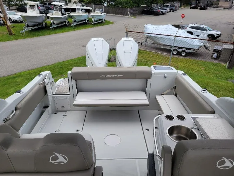 Slide: The Image of 2024 Finseeker 280 DC boat interior with twin engines, seating, and sink. - 2
