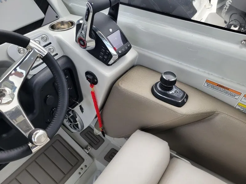 Slide: The Image of 2024 Finseeker 280 DC boat cockpit with steering wheel and control panel. - 8