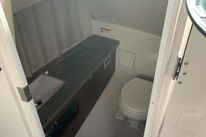 Slide: The Image of 2019 Four Winns H290 OB boat bathroom with sink and toilet. - 10