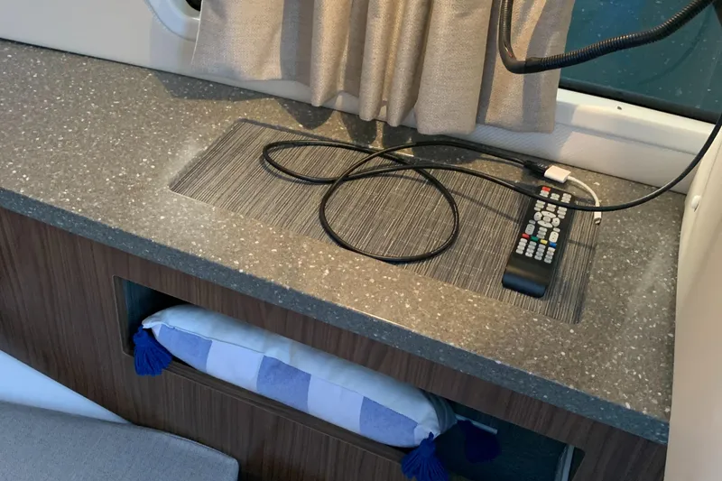 Slide: The Image of Interior of 2019 Four Winns H290 OB boat with countertop, remote, and storage. - 19