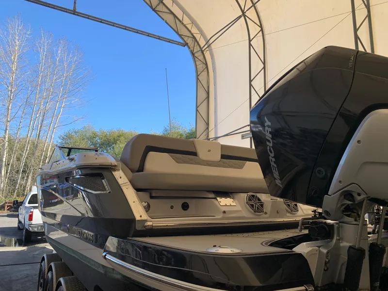 Slide: The Image of 2019 Four Winns H290 OB boat in storage with Mercury outboard motor. - 24