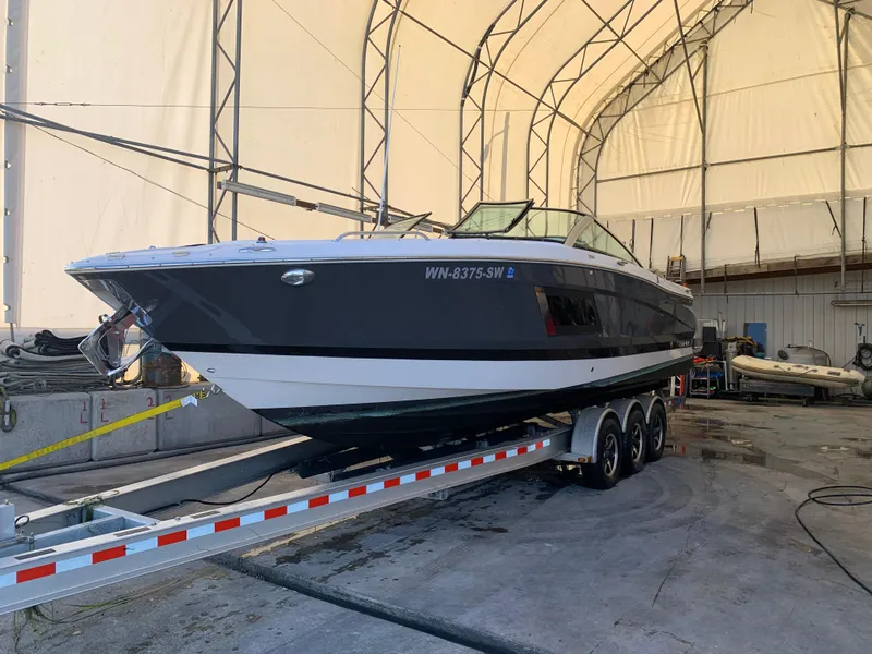 Slide: The Image of 2019 Four Winns H290 OB boat on trailer in storage facility. - 26