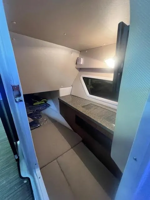 Slide: The Image of 2019 Four Winns H290 OB cabin interior with seating and window. - 27