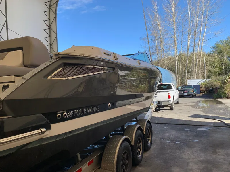Slide: The Image of 2019 Four Winns H290 OB boat on trailer in outdoor setting. - 3