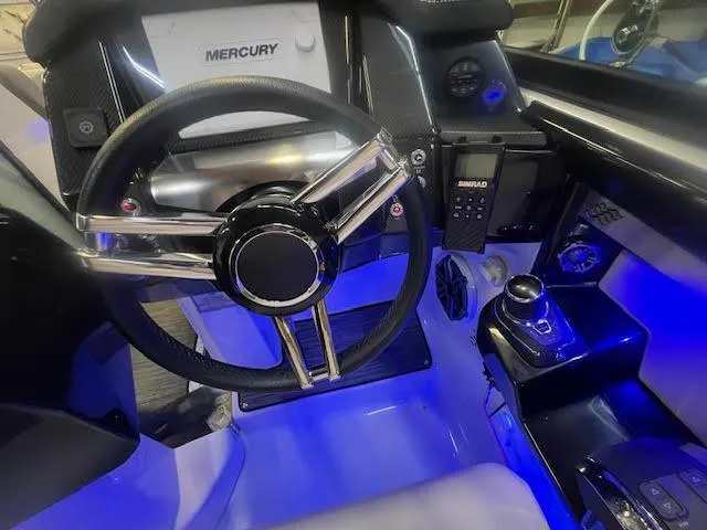 Slide: The Image of 2019 Four Winns H290 OB boat cockpit with illuminated controls and steering wheel. - 31