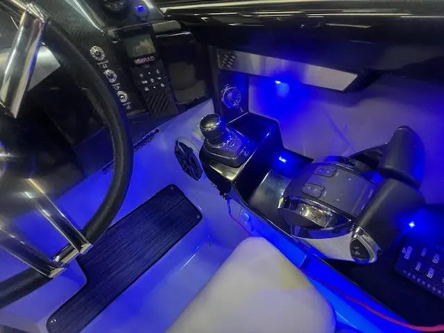Slide: The Image of 2019 Four Winns H290 OB boat cockpit with illuminated controls and steering wheel. - 32