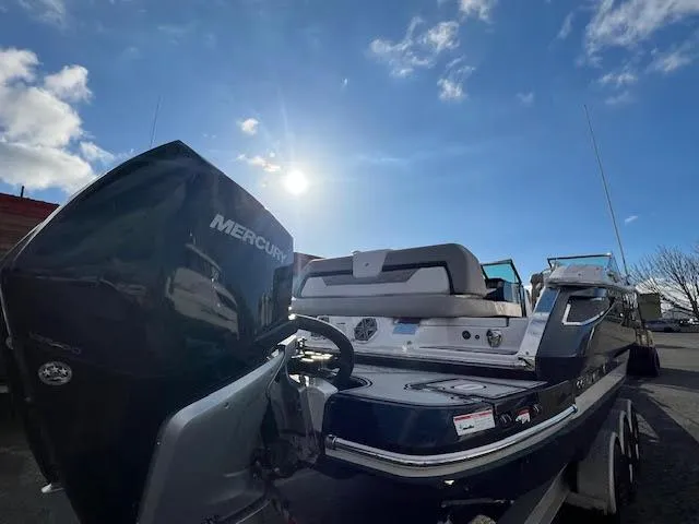 Slide: The Image of 2019 Four Winns H290 OB boat with Mercury outboard motor under a bright sky. - 34