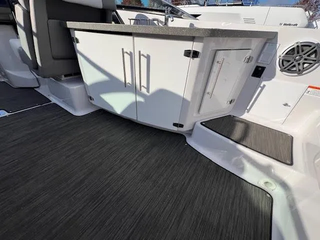 Slide: The Image of 2019 Four Winns H290 OB boat interior with sleek cabinetry and modern flooring. - 39