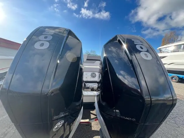 Slide: The Image of 2019 Four Winns H290 OB with dual outboard engines under a blue sky. - 47
