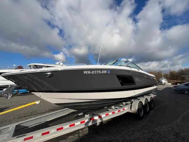 Slide: The Image of 2019 Four Winns H290 OB boat on trailer under cloudy sky. - 49