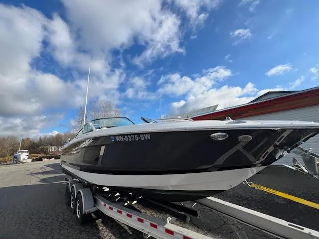 Slide: The Image of 2019 Four Winns H290 OB boat on trailer under blue sky. - 50