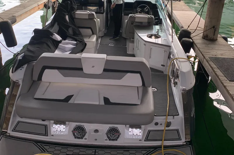 Slide: The Image of 2019 Four Winns H290 OB boat docked, featuring spacious seating and modern design. - 7