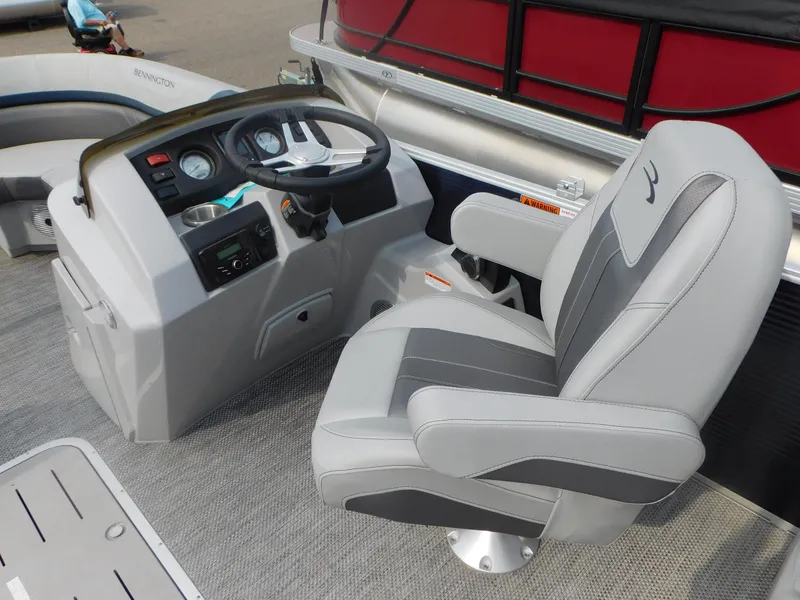 Slide: The Image of 2023 Bennington 22SXSR boat interior with steering console and captain's chair. - 5