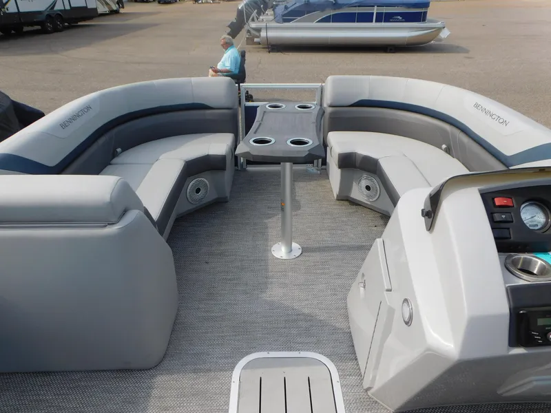 Slide: The Image of 2023 Bennington 22SXSR pontoon boat interior with plush seating and modern dashboard. - 7