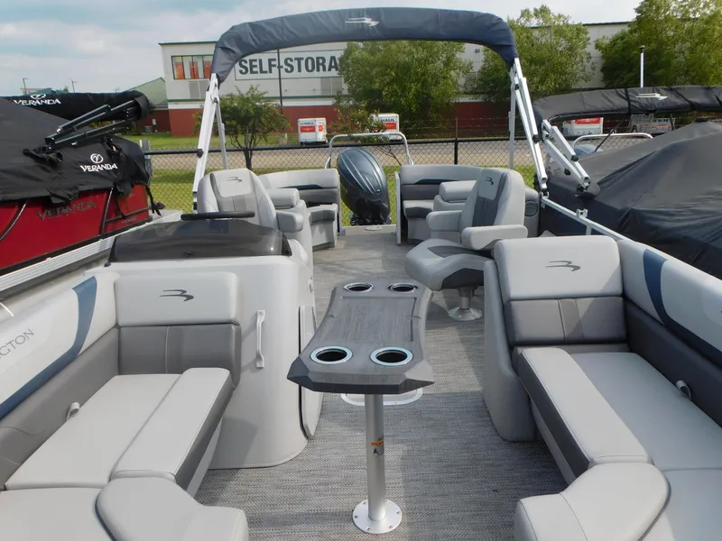Slide: The Image of 2023 Bennington 22SXSR pontoon boat interior with seating and table. - 8