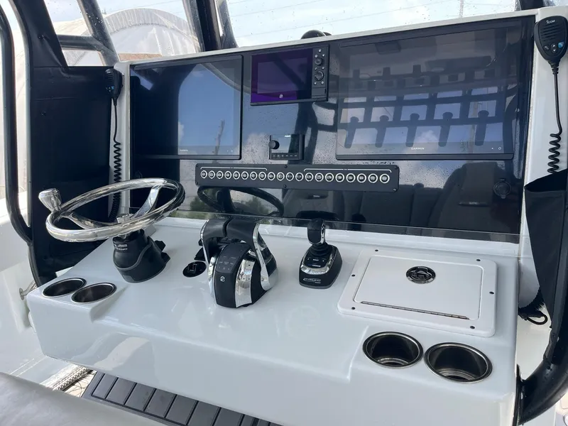 Slide: The Image of Control panel of a 2021 Freeman 37 VH boat with steering wheel and navigation equipment. - 16
