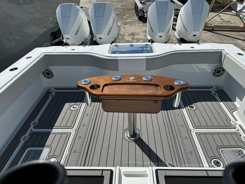 Slide: The Image of Freeman 37 VH 2021 boat deck with four outboard motors and wooden center console. - 7