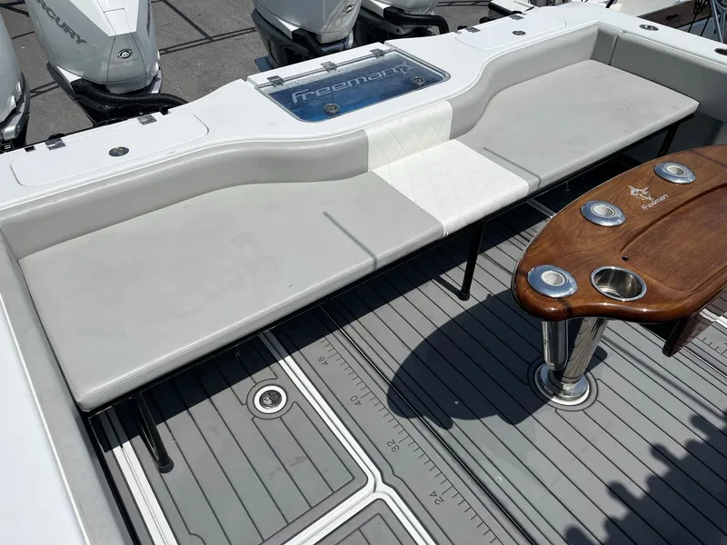 Slide: The Image of Freeman 37 VH 2021 boat interior with seating and wooden table. - 8