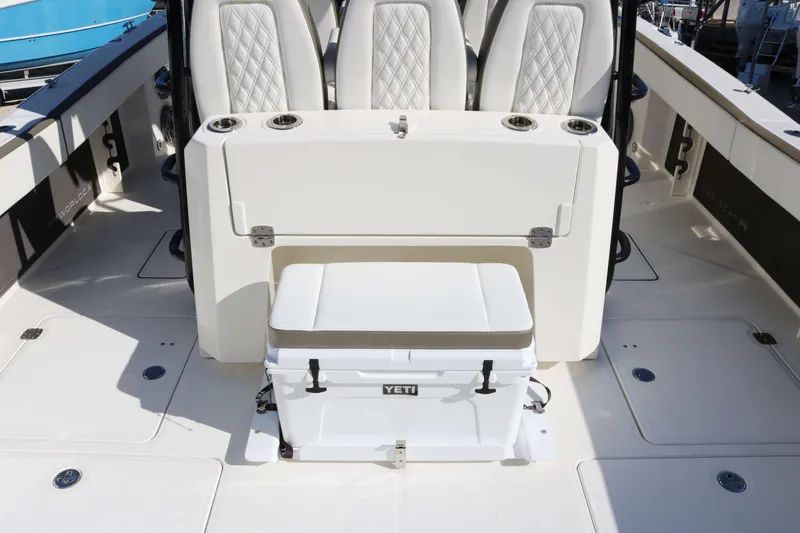 Slide: The Image of 2023 World Cat 400 CC-X boat interior with seating and Yeti cooler. - 14