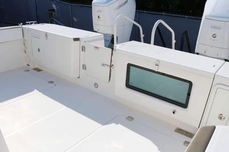 Slide: The Image of 2023 World Cat 400 CC-X boat deck with storage compartments and Mercury engines. - 16