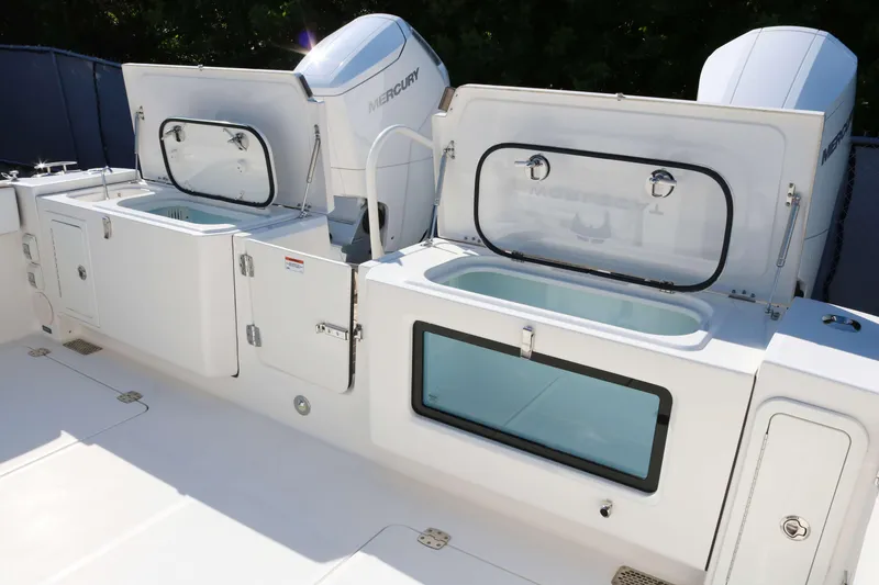 Slide: The Image of 2023 World Cat 400 CC-X boat with open storage compartments and Mercury engines. - 17