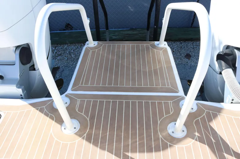 Slide: The Image of 2023 World Cat 400 CC-X boat deck with safety rails and wood-patterned flooring. - 18