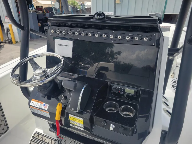 Slide: The Image of Control console of 2024 Wellcraft 222 Fisherman boat with steering wheel and instrument panel. - 12