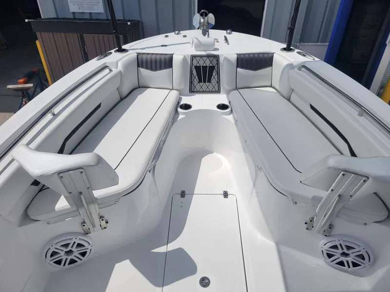 Slide: The Image of 2024 Wellcraft 222 Fisherman boat interior with white cushioned seating. - 13