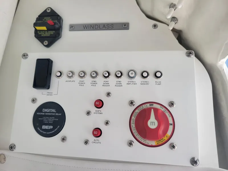 Slide: The Image of Control panel of a 2024 Wellcraft 222 Fisherman boat, featuring windlass and various switches. - 16