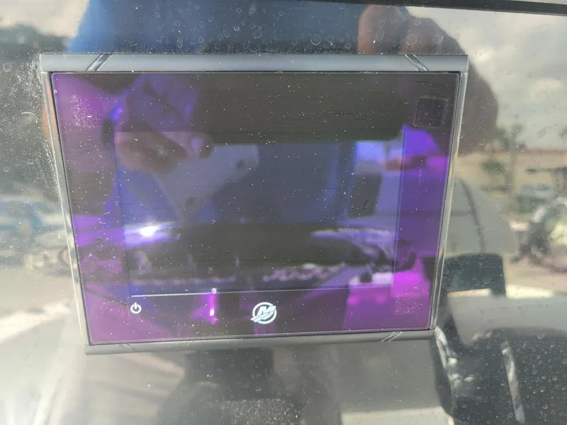 Slide: The Image of 2024 Wellcraft 222 Fisherman boat display screen with reflections. - 23