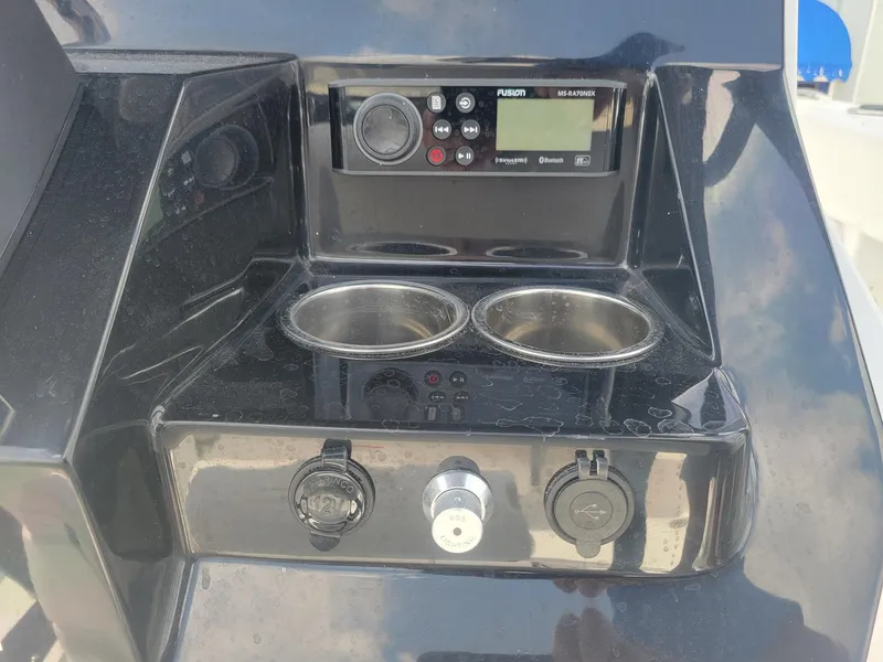 Slide: The Image of Control panel of 2024 Wellcraft 222 Fisherman boat with cup holders and audio system. - 24