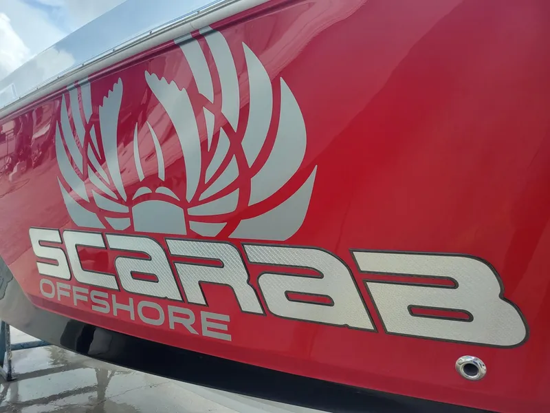 Slide: The Image of 2024 Wellcraft 222 Fisherman Scarab Offshore logo on red hull. - 4