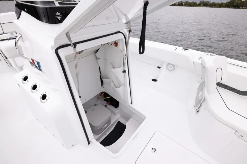 Slide: The Image of 2024 Wellcraft 222 Fisherman boat interior with open storage compartment. - 41
