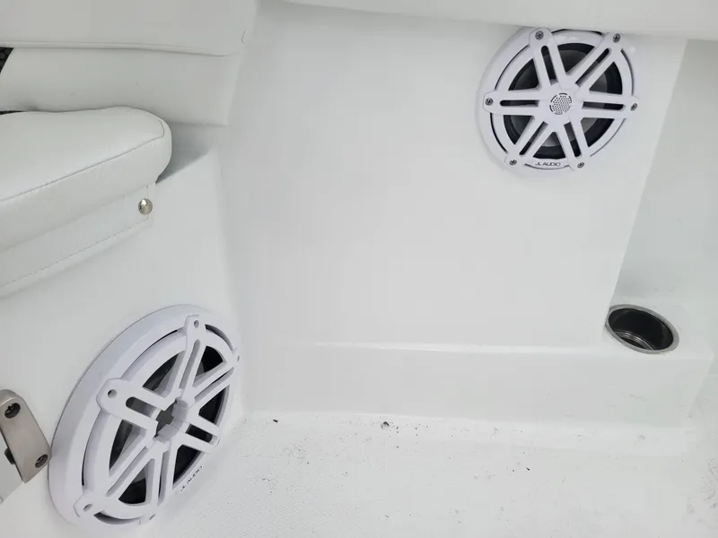 Slide: The Image of 2024 Wellcraft 222 Fisherman boat interior with white speakers and seating. - 45