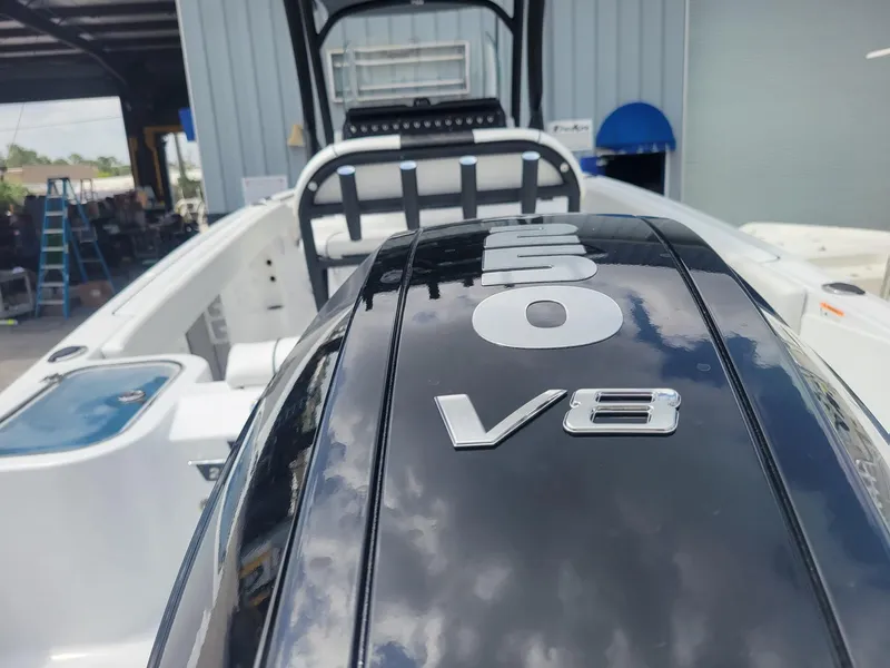 Slide: The Image of 2024 Wellcraft 222 Fisherman with powerful V8 engine in a boatyard. - 7