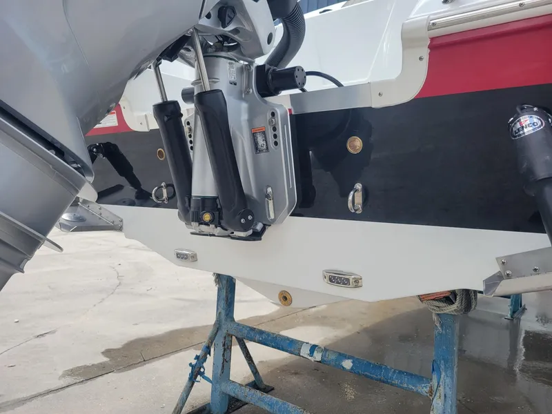 Slide: The Image of 2024 Wellcraft 222 Fisherman boat transom and outboard motor on a stand. - 8