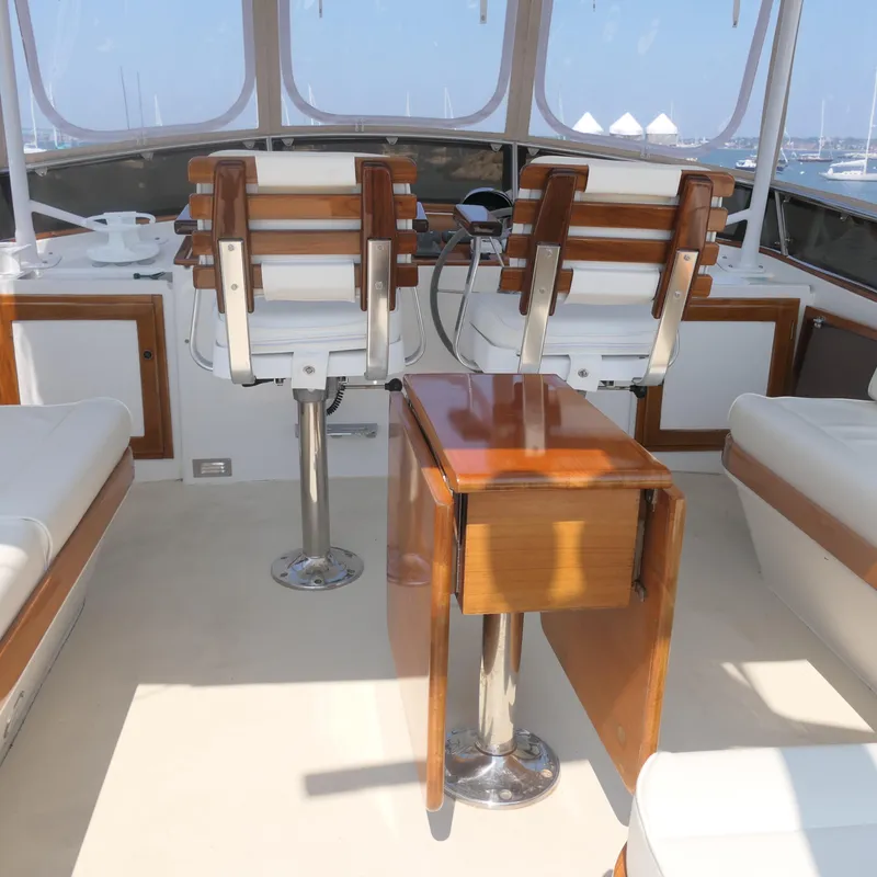 Slide: The Image of Interior of 2020 Alden Motor Yacht with wooden and white seating. - 16