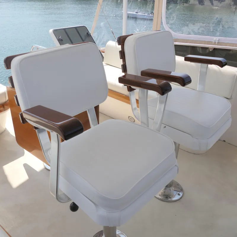 Slide: The Image of Luxury seating on 2020 Alden Motor Yacht with white cushions and wooden armrests. - 19