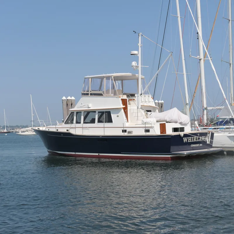 Slide: The Image of Alden 2020 motor yacht docked in a marina, clear sky background. - 2