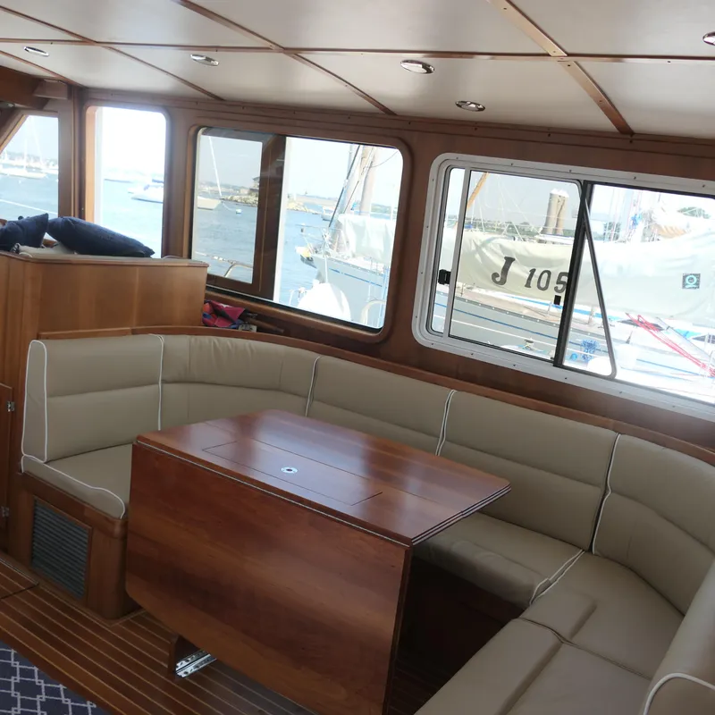Slide: The Image of Interior of 2020 Alden Motor Yacht with elegant seating and wooden table. - 22