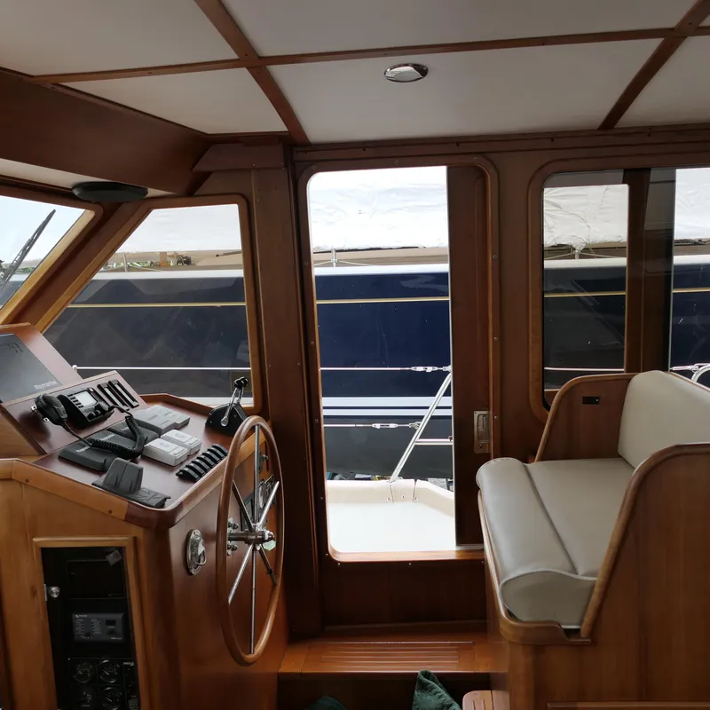 Slide: The Image of Interior of 2020 Alden Motor Yacht with wooden helm and seating. - 25