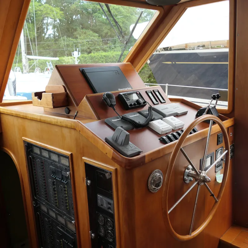 Slide: The Image of Control panel of a 2020 Alden Motor Yacht with steering wheel and navigation equipment. - 26