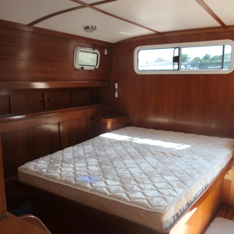 Slide: The Image of Alden Motor Yacht 2020 interior cabin with wooden finish and bed. - 27