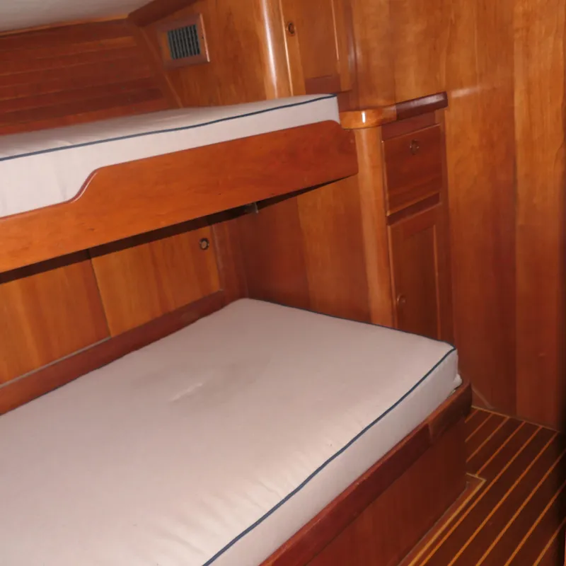 Slide: The Image of Interior of 2020 Alden Motor Yacht with wooden bunk beds and cabinetry. - 30