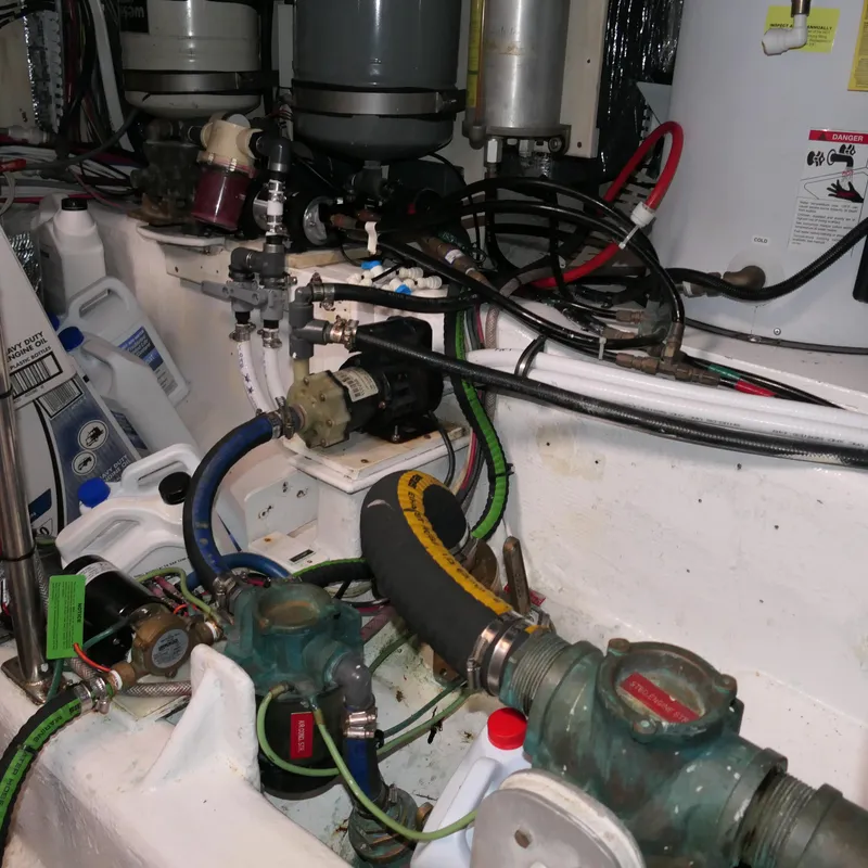 Slide: The Image of Engine room of 2020 Alden Motor Yacht with various mechanical components and hoses. - 32