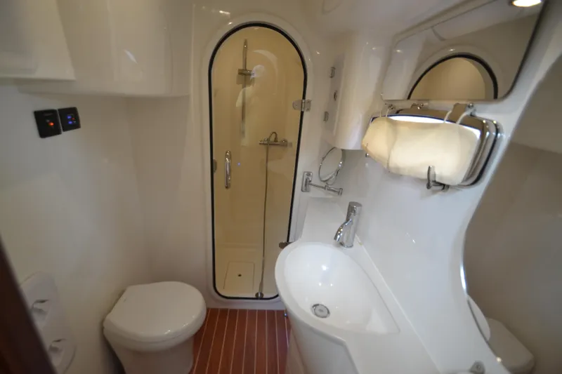 Slide: The Image of Modern bathroom in 2022 ArrowCat 42 Coupe, featuring a shower, toilet, and sink. - 15