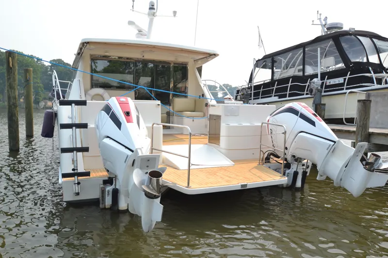 Slide: The Image of 2022 ArrowCat 42 Coupe luxury yacht docked with twin outboard engines. - 2